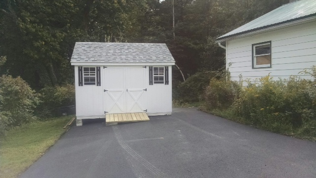10x12 white A-Frame shed with black shutters and natural ramp delivered to Nassau, NY